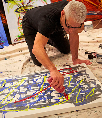 Dr. Kiltz creating a large scale painting in his studio.