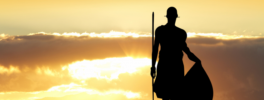 massai warrior standing in the sunset
