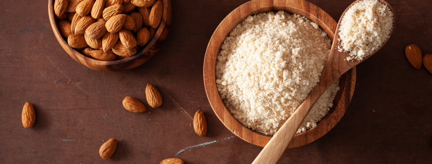 whole almonds and almond flour in bowls