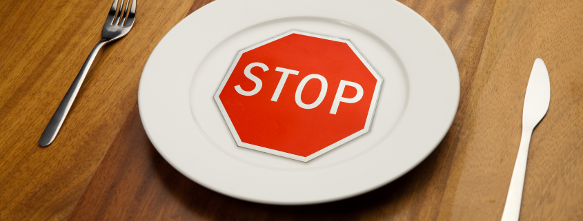 diet concept - stop sign on the plate