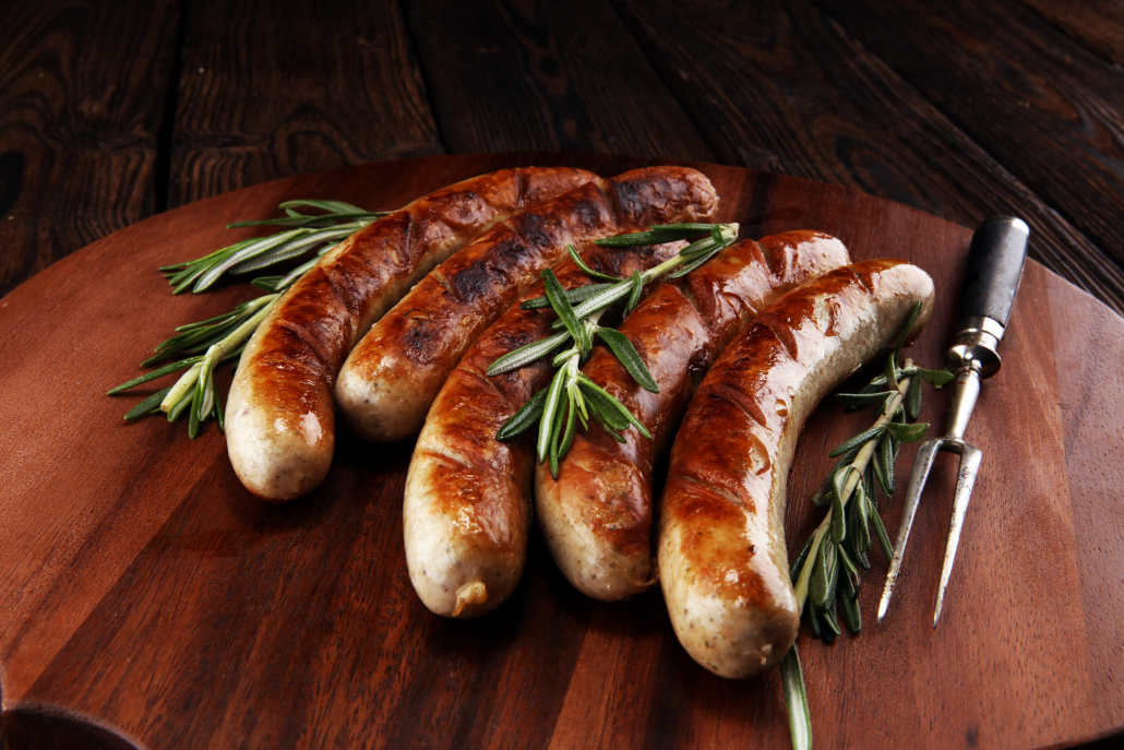 Grilled sausages with spices on a wooden table - Home-made Pork Sausages for barbecue