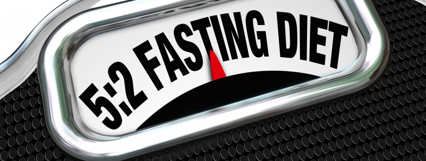 The words 5:2 Fasting Diet on a scale display to symbolize the new dieting fad or craze where you reduce calorie intake to lose weight