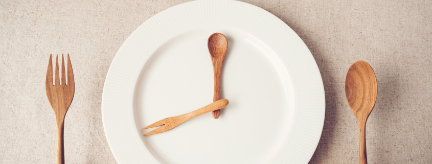 white plate with spoon and fork, Intermittent fasting concept, ketogenic diet, weight loss