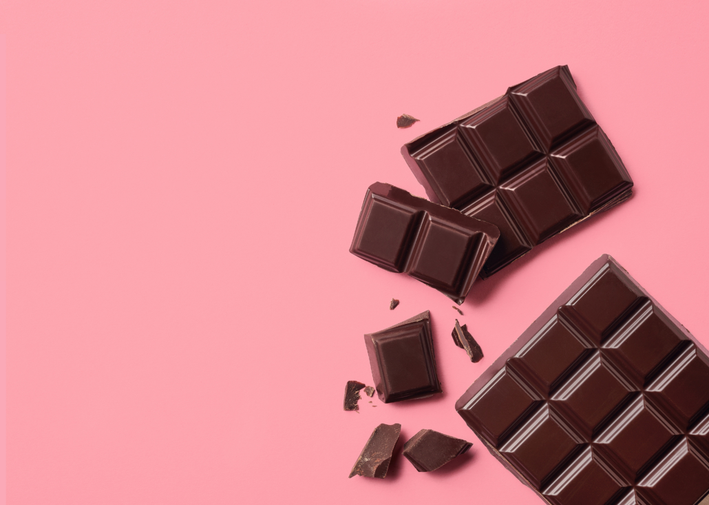 Dark chocolate on pink background. Top view