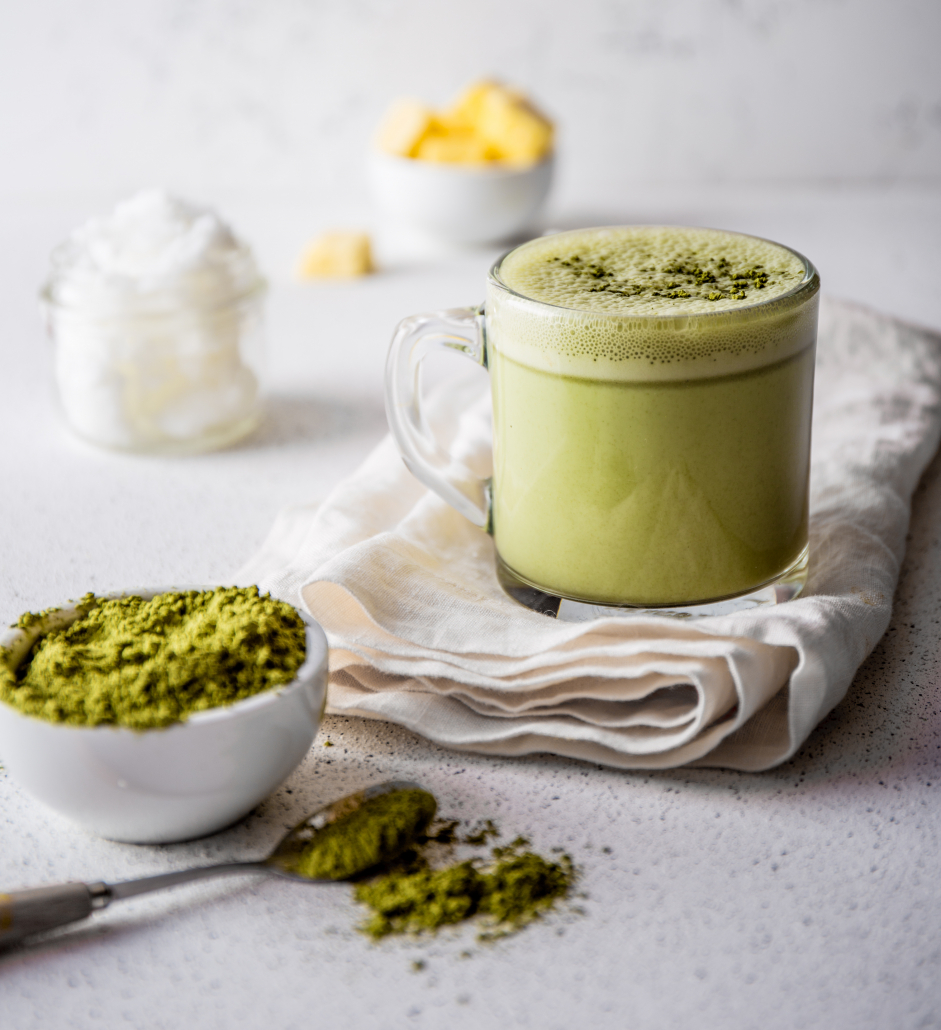 BULLETPROOF MATCHA. Ketogenic keto diet hot drink. Tea matcha blended with coconut oil and butter. Cup of bulletproof matcha and ingredients on white background.