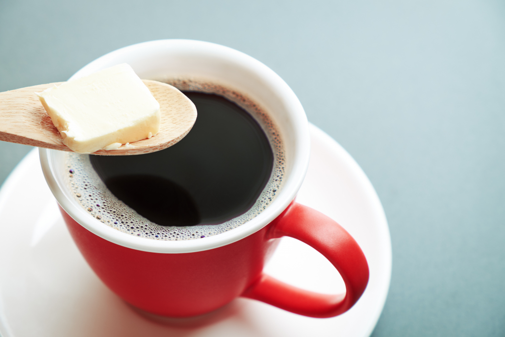 Bulletproof coffee, cup and butter in spoon