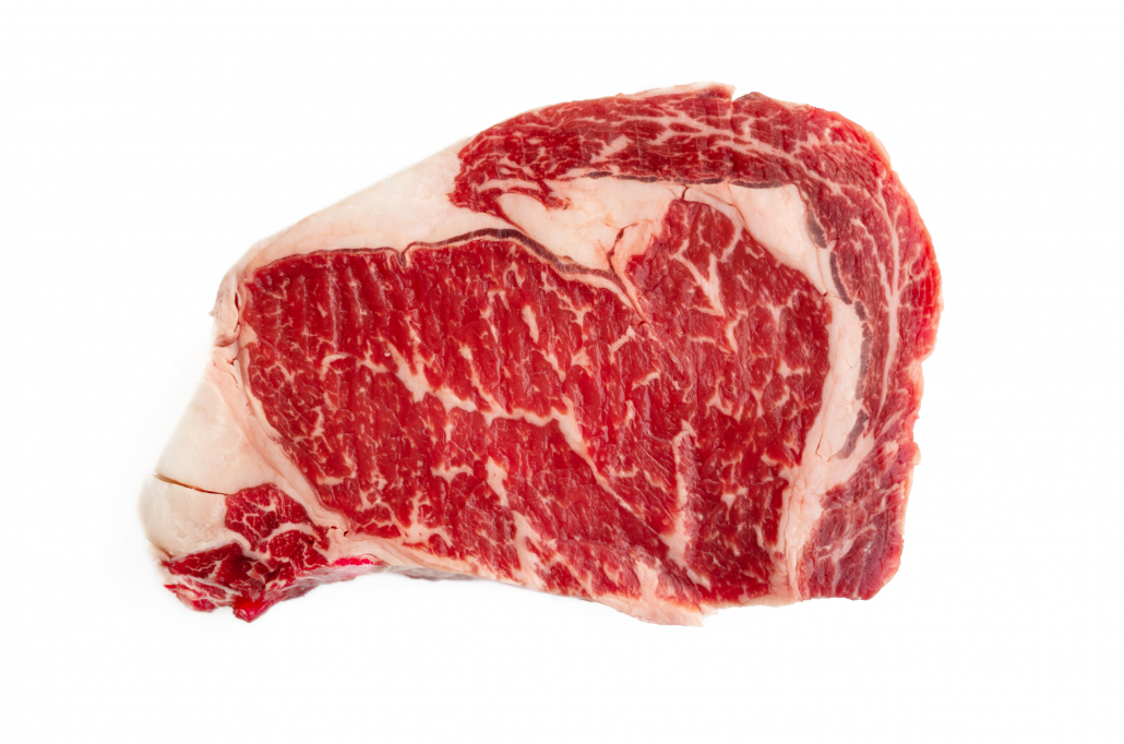 Raw uncooked prime ribeye boneless steak isolated on white background