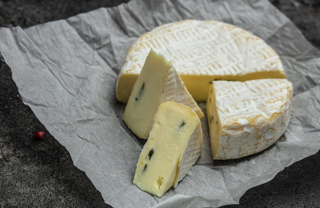close up mild blue cheese. cambozola cheese, German creamy blue brie Cambozola soft cheese with blue mould close up. french cuisine.