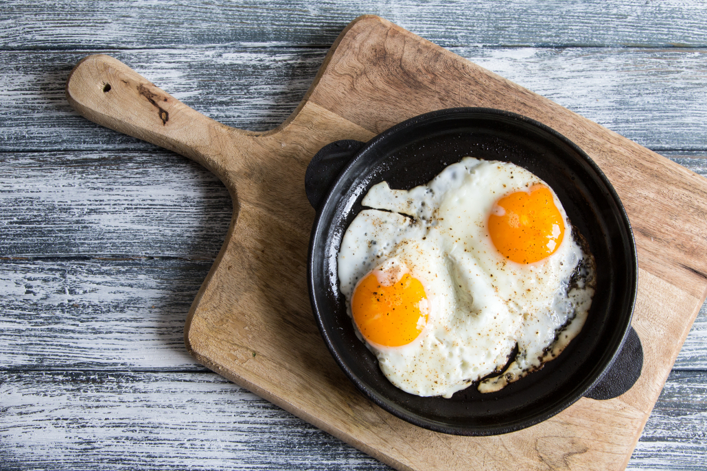 Fried egg. Close up view of the fried egg on a frying pan/