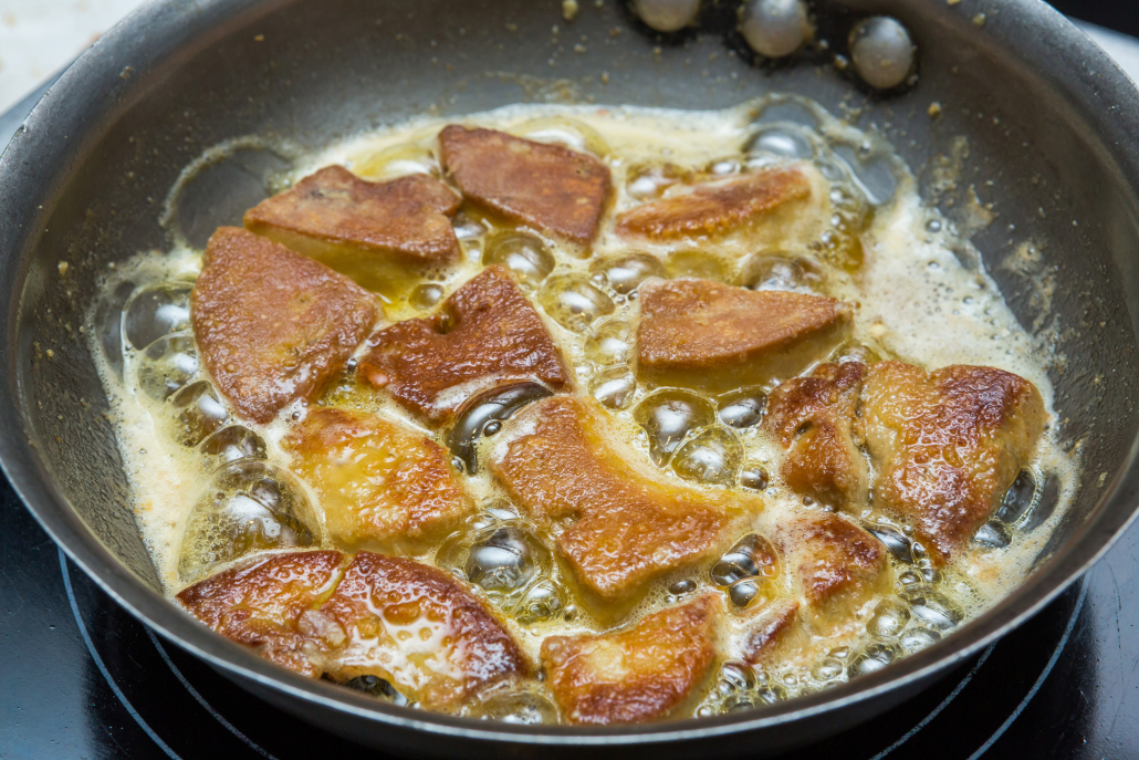 Close up foie gras cooking in iron pan