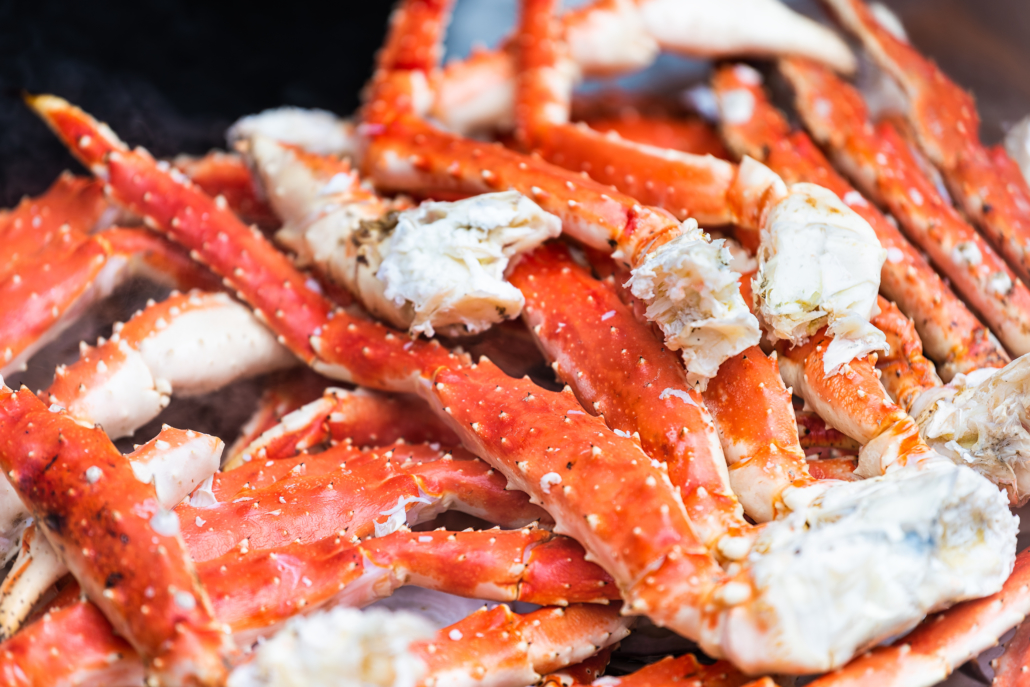 Tokyo, Japan Street in Tsukiji outer market in Ginza with closeup retail sample display of cooked red crab lobster legs white meat