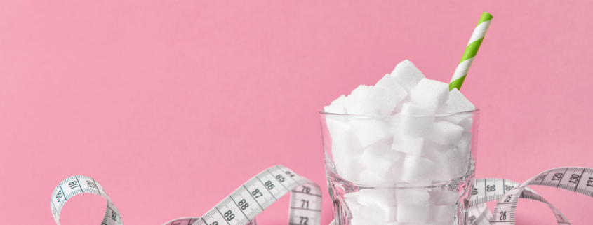Glass with sugar cubes and measuring tape. Weight control diet concept