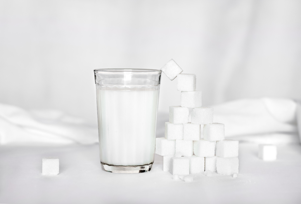 glass of milk with sugar molecules 