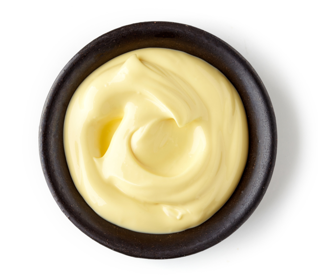Mayonnaise in round dish isolated on white background, top view