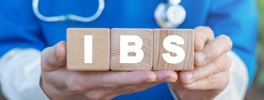 Physician holds three wooden blocks with IBS acronym. IBS Irrita
