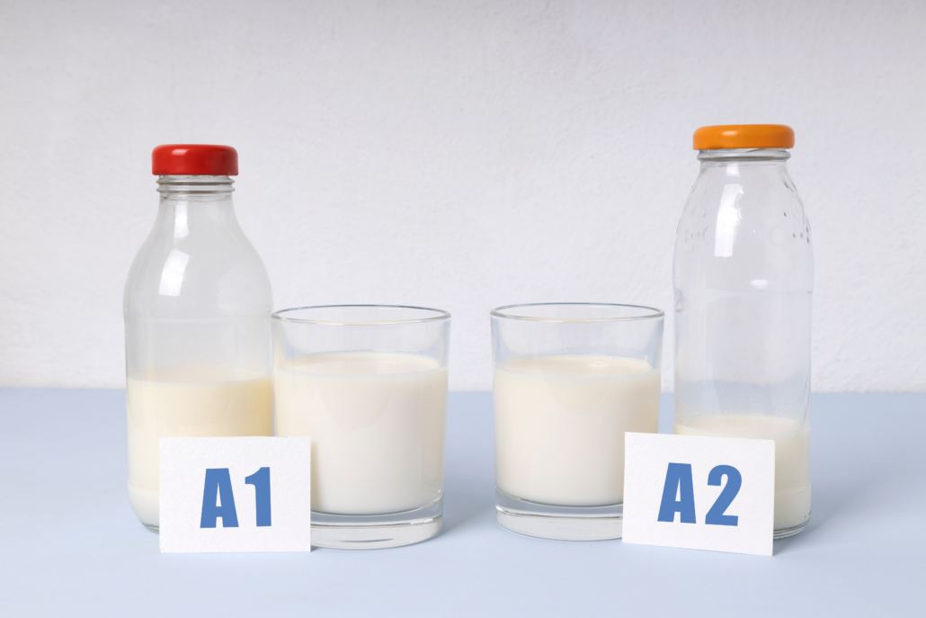 Two bottles and glass of milk different types.A1 and A2 milk var