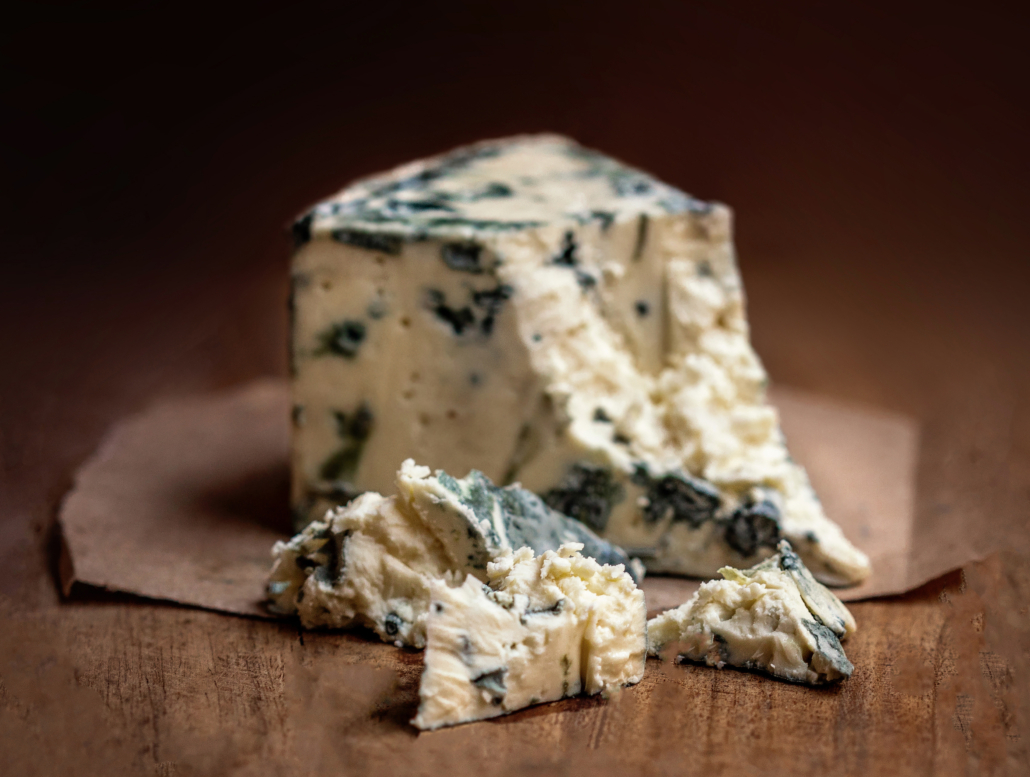 Blue cheese Gorgonzola on a rustic wooden background. Mold cheese with copyspace