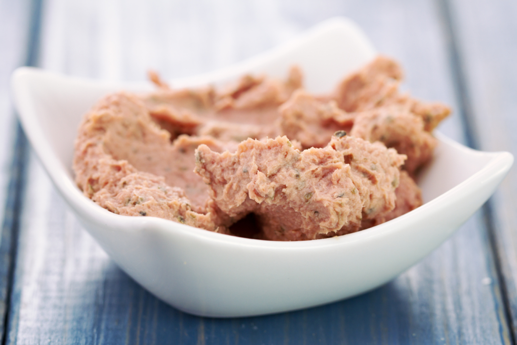 duck pate in bowl on blue woden background