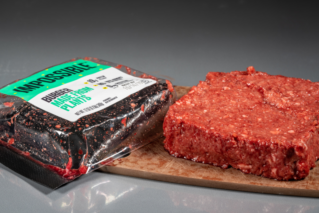 MORGANTOWN, WV - 8 October 2019: Packaging for Impossible Foods burger made from plants with raw product on steel background