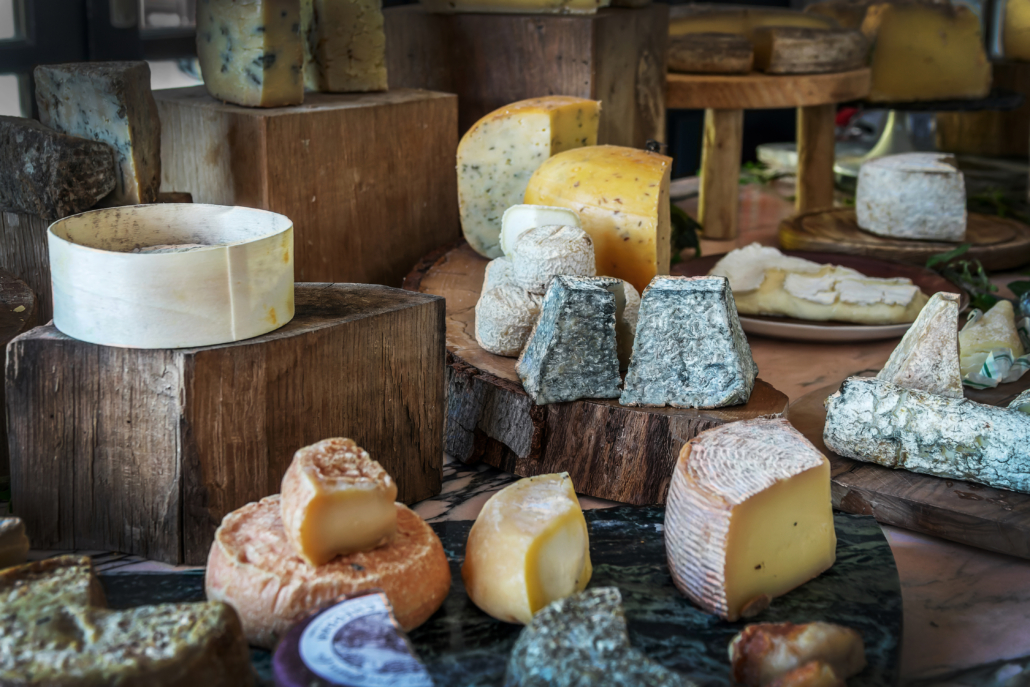 Large choice of French ripened cheese on a wooden rustic board