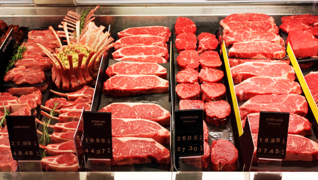 Selection of different cuts of fresh raw red meat in a supermarket