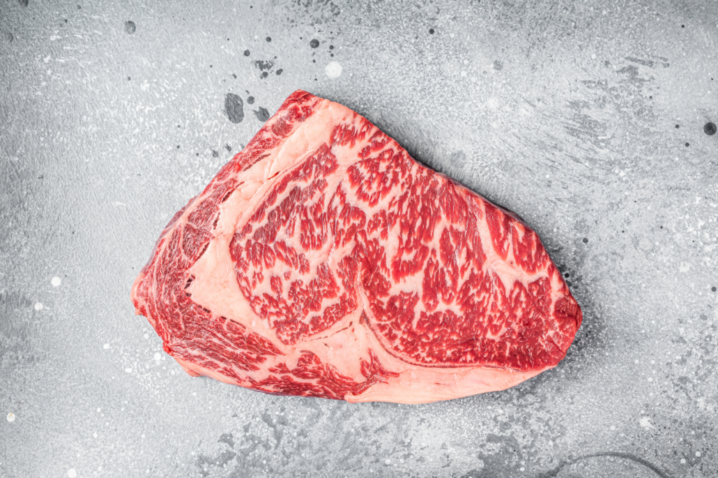 Japanese wagyu rib eye beef meat steak. Gray background. Top view.
