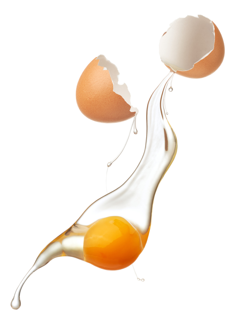 Cracked egg shell revealing egg yolk and white isolated
