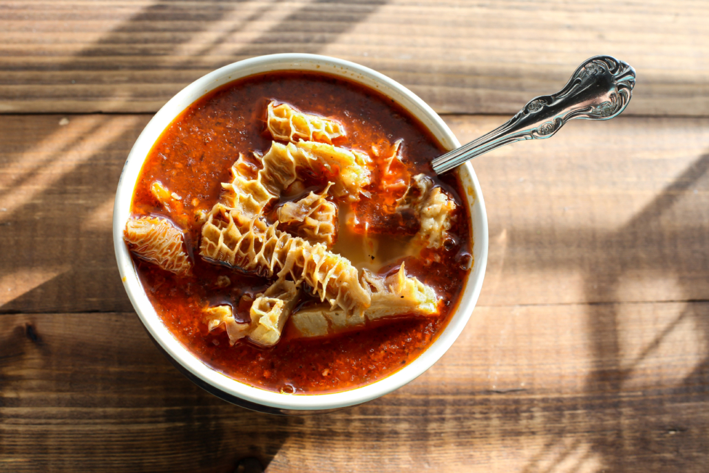 Beef tripe soup on wooden table top view